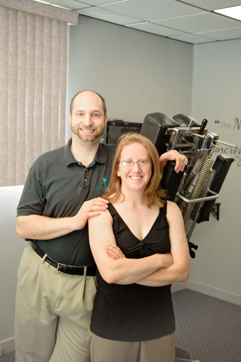 Dr. Dan and Dr. Kristen Denette standing together in their office